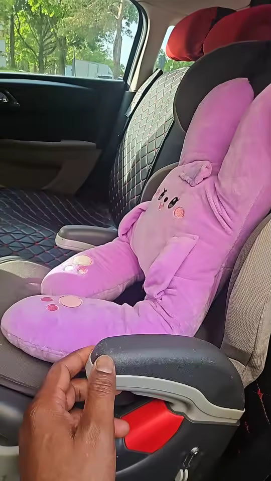 Customer photo of a pink RideNuzzle travel pillow installed on a vehicle seat.